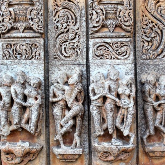 intricate stone carvings and worn statues of a half dozen duos and trios embracing