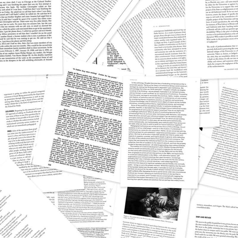 scattered papers with thick lines of text, including one page with a blurry photo